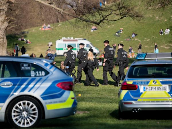 Polizisten patrouillieren durch den Englischen Garten in München, um Corona-Verstöße zu unterbinden. 