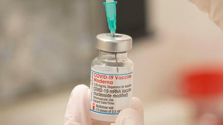 Ein Mitarbeiter des Gesundheitswesens füllt eine Spritze mit einer Dosis des Corona-Impfstoffs von Moderna für eine Auffrischimpfung.