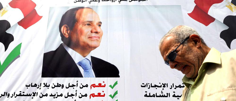 Ein Mann passiert ein Banner in Kairo, das für al Sisi wirbt.