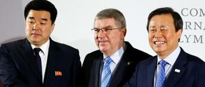 IOC-Präsident Thomas Bach besiegelt mit dem Chef des nordkoreanischen NOKs Kim Il Guk (l.) und dem südkoreanischen Sportminister Do Jong-Hwan die Teilnahme Nordkoreas an den Winterspielen 2018.