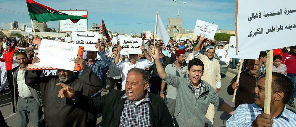 Aufgebrachte Männer demonstrieren in Libyens Hauptstadt Tripolis gegen die Macht der Milizen. Auf ihren Plakaten steht unter anderem "Ja zum Rechtsstaat", oder "Ja zum Nationalen Dialog". 