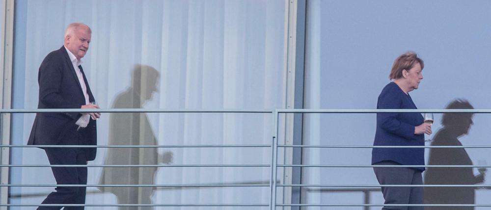 Bundeskanzlerin Angela Merkel (r, CDU) geht auf einem Balkon des Bundeskanzleramts vor Horst Seehofer, Bundesminister für Inneres, Heimat und Bau. 