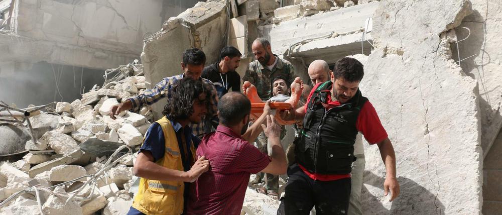 Im Norden von Aleppo tragen Männer einen Verletzten aus den Trümmern eines Hauses. AFP PHOTO / AMEER ALHALBI