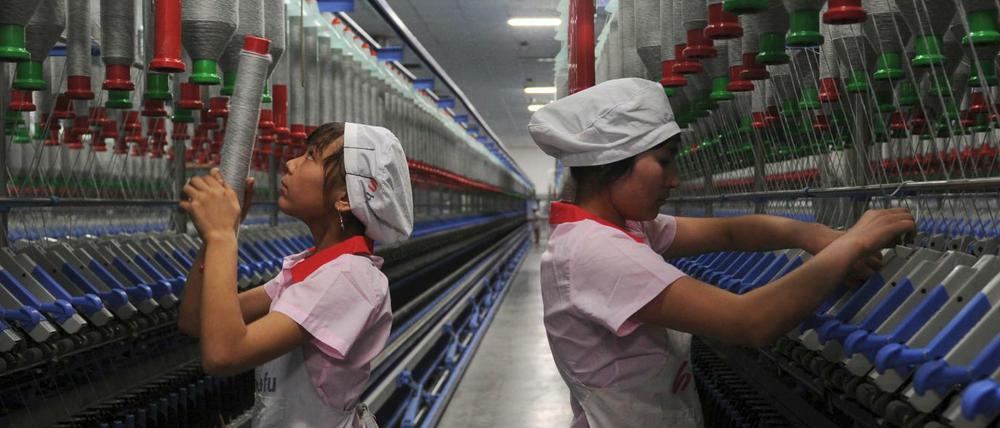 Uigurische Frauen arbeiten im Jahr 2012 in einer Textilfirma in Xinjiang in China.