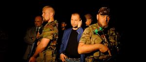 Der selbsternannte Premierminister der von Separatisten ausgerufenen Volksrepublik Donetsk, Borodai (mitte), steht inmitten seiner Kämpfer.