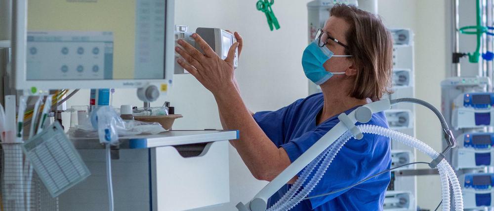 Eine Krankenschwester prüft das Beatmungsgerät eines Covid-19-Patienten.