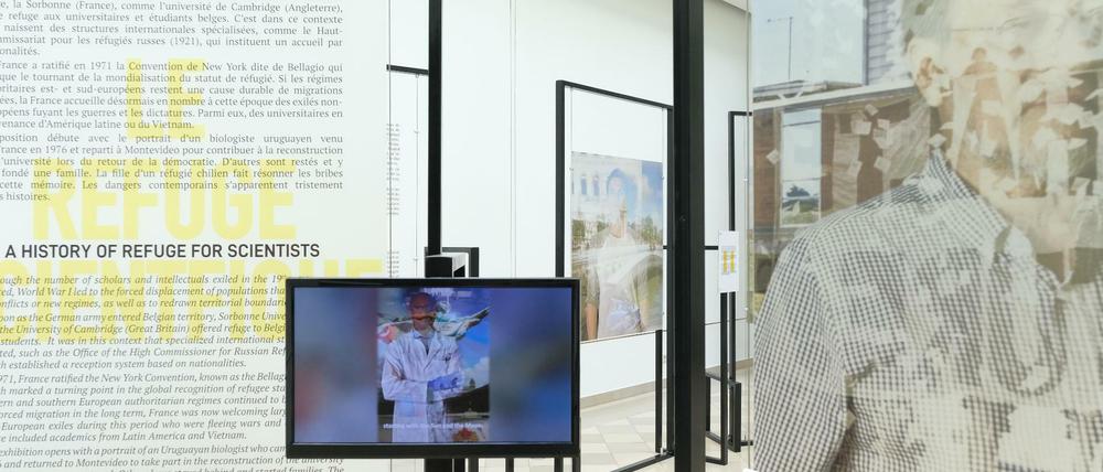 In einem Ausstellungsraum sind verfremdete Porträts und ein Bildschirm zu sehen.
